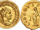 a gold coin with an image of a man holding a sword