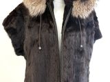 the jacket is made of fur and has a hood with a fur collar