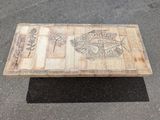 a wooden table that has a picture on it