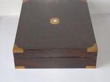 a wooden box with a brown lid on a white surface