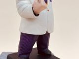 a figurine of a man in a suit on top of a box