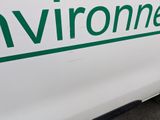a white van with green writing on the side of it