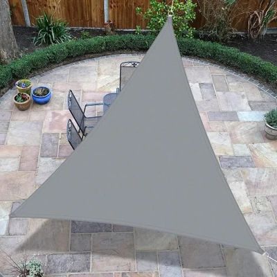 an aerial view of a patio area with a table, chairs, and a large triangle shade