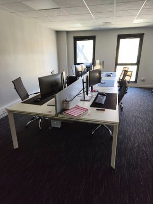 an image of an empty office with a desk and two monitors