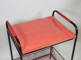 a metal cart with a red tray on it