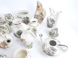many pieces of pottery that are sitting on a table