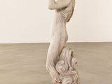 statue of a woman holding a bird in her hand