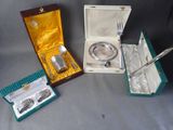 three silverware items sitting in a box on a table