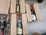 several bottles of wine are sitting in a cardboard box on the floor
