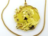 l'image d'une pièce d'or sur laquelle figure le visage d'une femme