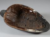 a brown and black bowl sitting on a white surface