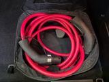a bag with a red and black hose in it