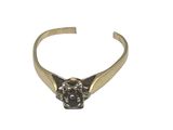 a close up of a gold ring with a black diamond on it