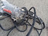 an image of a corded drill on the ground