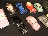 several toy cars are lined up in a row on a black surface