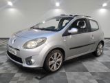 a picture of a silver small car parked in a garage