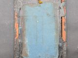 an image of a picture of a blue door in a gray wall