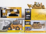 three different models of construction vehicles in the box