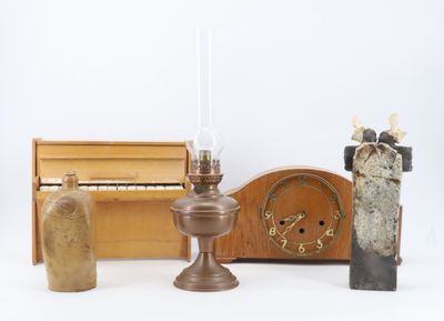 several pieces of art are displayed on a white surface next to a piano