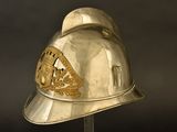 a silver helmet with a gold emblem on it