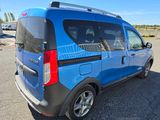 a blue van that is parked in a parking lot