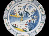 an image of a blue and white plate with a painting on it