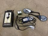 a remote, a cell phone, a mirror, and other items on the ground
