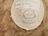 a brown teddy bear with a tag on it ' s head