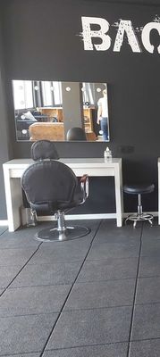 a large room with chairs and mirrors in it