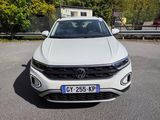 the front view of a white volkswagen suv parked in a parking lot