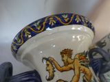 a close up of a vase with a lion on it