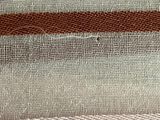 a close up of a piece of fabric with a brown stripe