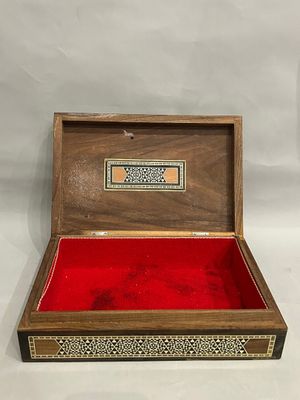 an old wooden box with a red velvet lining inside