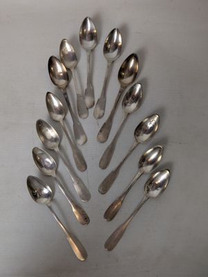 a lot of spoons arranged in a circle on the table
