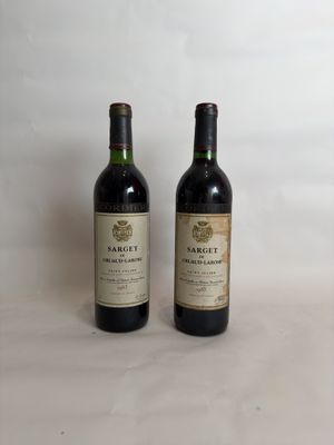 two bottles of wine sitting next to each other on a table