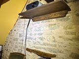 a television on a shelf above a bed in a room