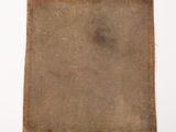 a close up of a piece of cloth on a white surface
