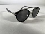 a close up of a pair of black sunglasses on a white surface