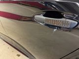 a close up of a car door handle with a sticker on it