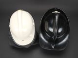 two hard hats sitting next to each other on a table