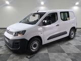la camionnette blanche est garée sur un sol carrelé en damier