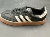 a close up of a pair of black and white adidas sneakers
