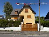 a yellow house with a crane on top of it