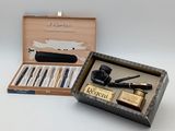 a box with a pen, a pipe, a lighter, and a lighter in it