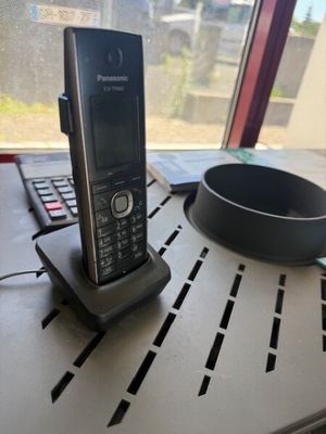 a cell phone sitting on top of a table next to a laptop