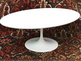 a white table with a white top on a rug