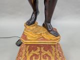 an image of a statue of a man standing on top of a base