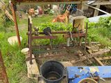 a bucket of food sitting on the ground next to a blue machine