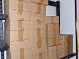 a large stack of boxes sitting on a shelf in a room