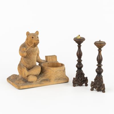 two candlesticks and a bear figurine on a white background
